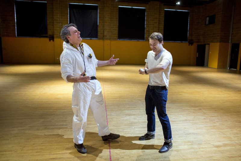 Gabriel Rhoads, left, in rehearsal character as "Doc" (Rhoads will not be Doc during the event) and Seth Porges, as Match, members of BBQ Films, talk while setting up for an event based on the movie Back To The Future at St. Patricks Youth Center in New York, NY on March 2, 2014. On March 22nd and 23rd the group will hold a ticketed event there based on the school dance scene in Back To The Future. The movie will also be screened.