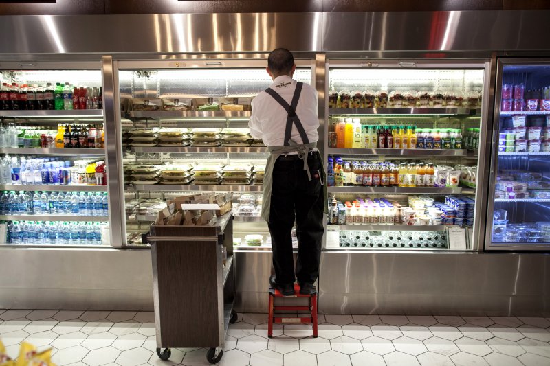 Barista Hing Wu stocks a retail section of Herb N' Kitchen, a new dining area at the Hilton Midtown in New York, NY on Sept. 17, 2013. The restaurant, which emphasizes ready-to-go and quickly prepared made-to-order foods, opened in July. 

CREDIT: Brian Harkin for The Wall Street Journal
FIXDECODE_Hilton