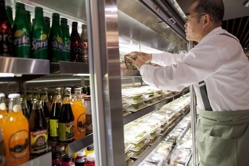 Barista Hing Wu stocks a retail section of Herb N' Kitchen, a new dining area at the Hilton Midtown in New York, NY on Sept. 17, 2013. The restaurant, which emphasizes ready-to-go and quickly prepared made-to-order foods, opened in July. 

CREDIT: Brian Harkin for The Wall Street Journal
FIXDECODE_Hilton
