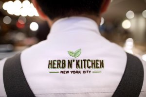 Barista Jose M. Flores wears his work uniform bearing the name of Herb N' Kitchen, a new dining area at the Hilton Midtown in New York, NY on Sept. 17, 2013. The restaurant, which emphasizes ready-to-go and quickly prepared made-to-order foods, opened in July. 

CREDIT: Brian Harkin for The Wall Street Journal
FIXDECODE_Hilton