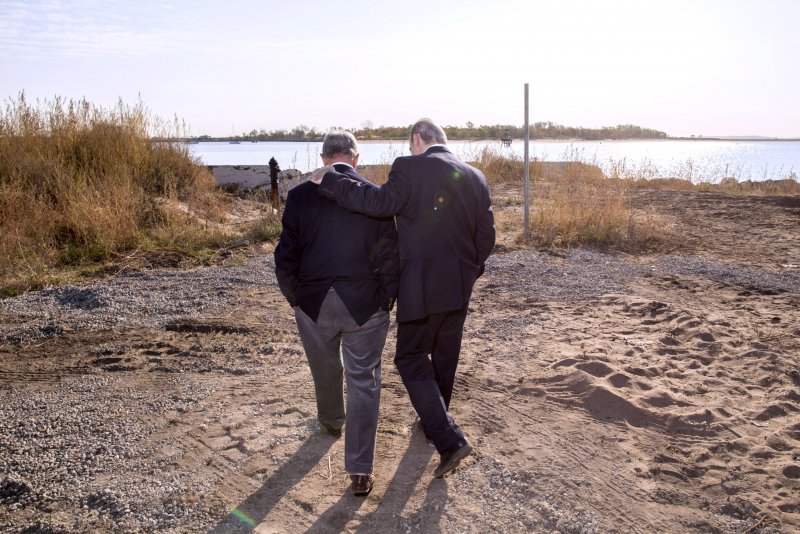 Mayor Michael R. Bloomberg, left, walks and talks with city council member James S. Oddo while visiting a parks department project to build sand dunes at Crescent Beach in Staten Island, NY on Oct. 29, 2013. Bloomberg visited storm-affected sites in Staten Island, The Rockaways and Coney Island on the anniversary of Hurricane Sandy.